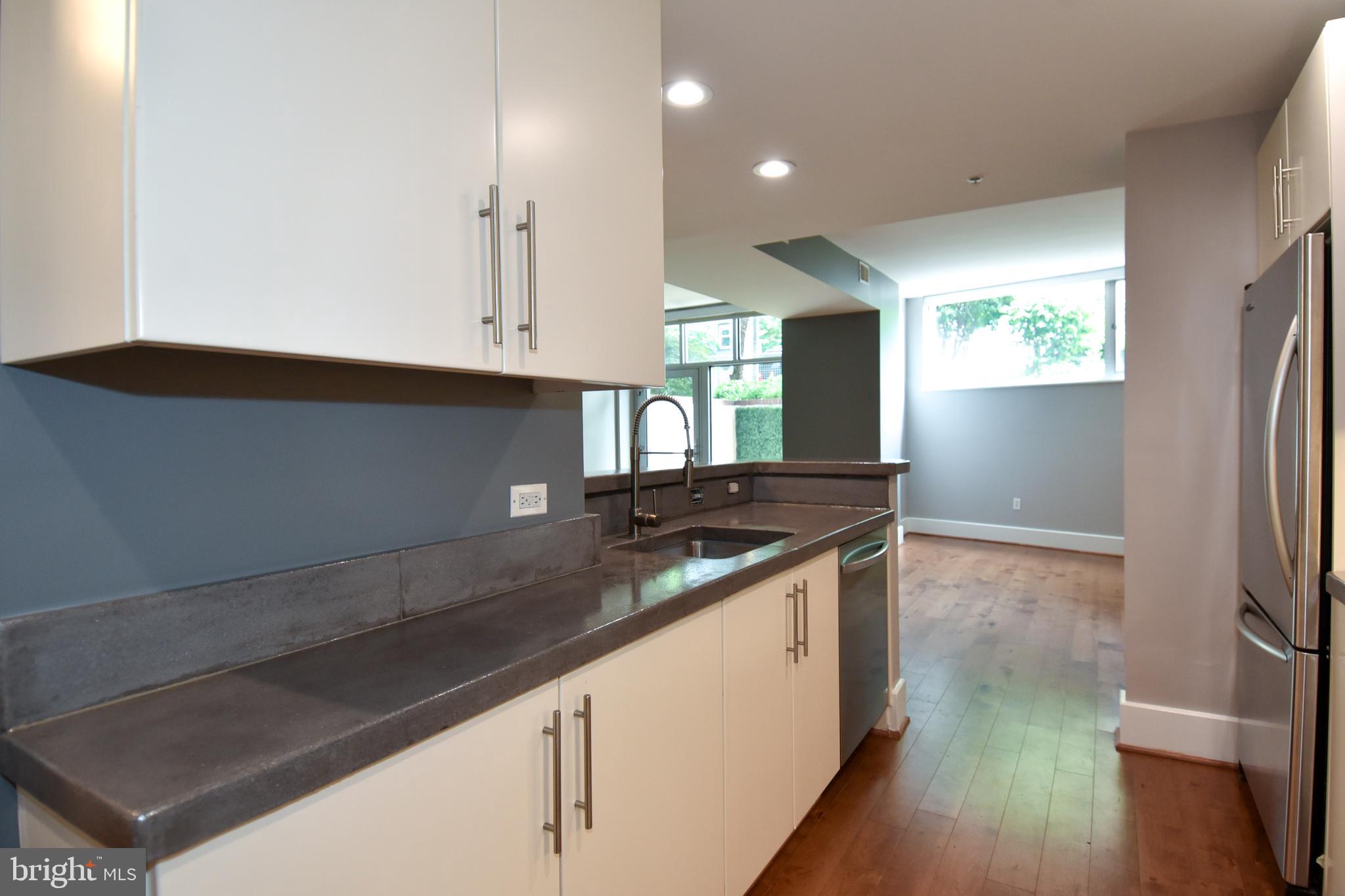 2100 11th Street Northwest, Unit G02 Washington, DC 20001 - Photo 22 of 36 a kitchen with stainless steel appliances granite countertop a sink and a stove