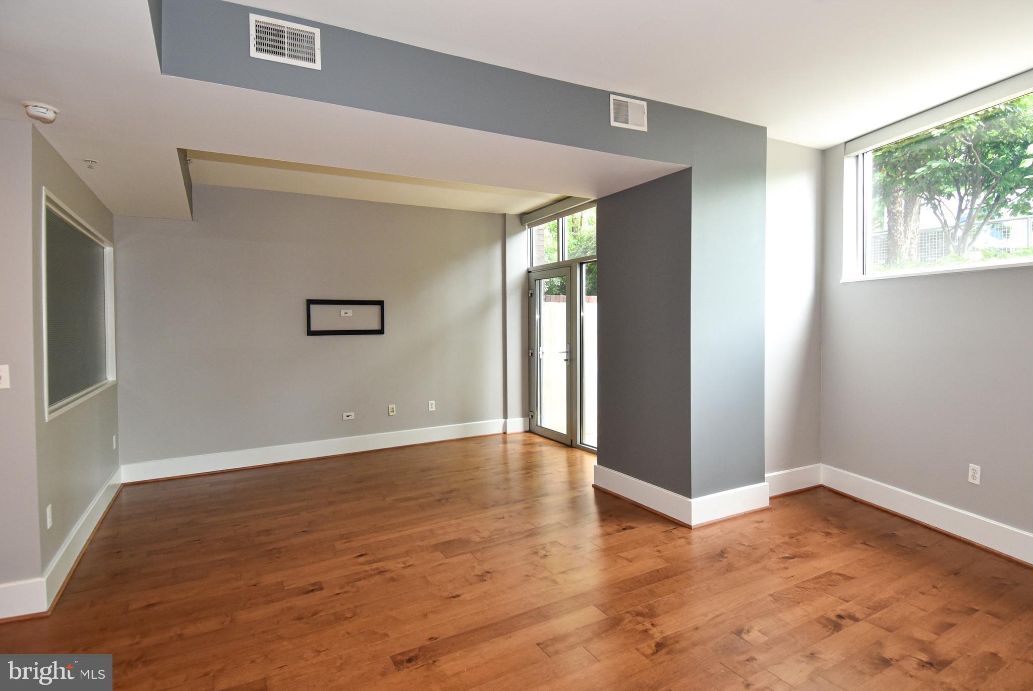 2100 11th Street Northwest, Unit G02 Washington, DC 20001 - Photo 24 of 36 a view of an empty room with wooden floor and a window