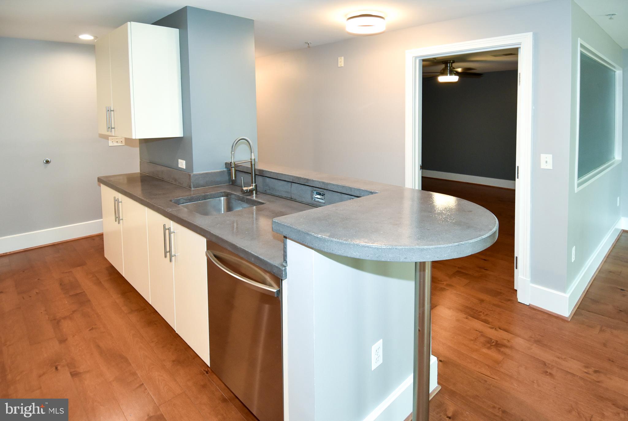 2100 11th Street Northwest, Unit G02 Washington, DC 20001 - Photo 25 of 36 a kitchen with a sink and chandelier