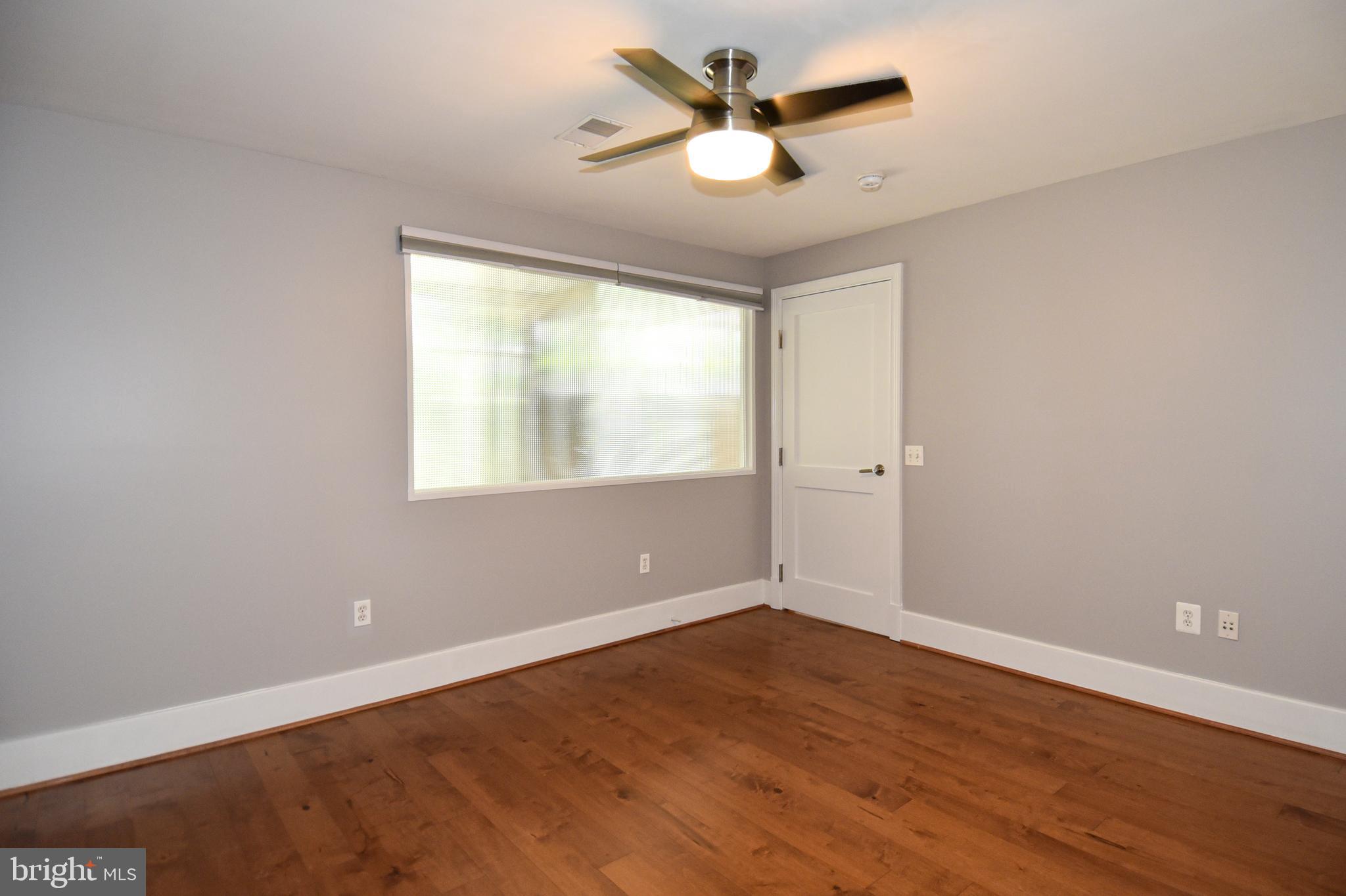 2100 11th Street Northwest, Unit G02 Washington, DC 20001 - Photo 27 of 36 an empty room with wooden floor and windows