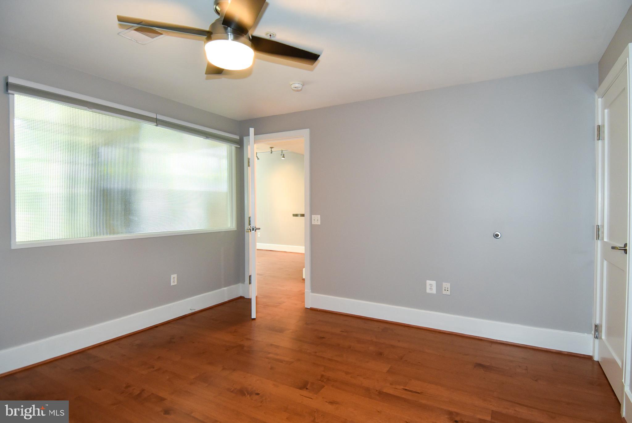 2100 11th Street Northwest, Unit G02 Washington, DC 20001 - Photo 28 of 36 an empty room with wooden floor and windows