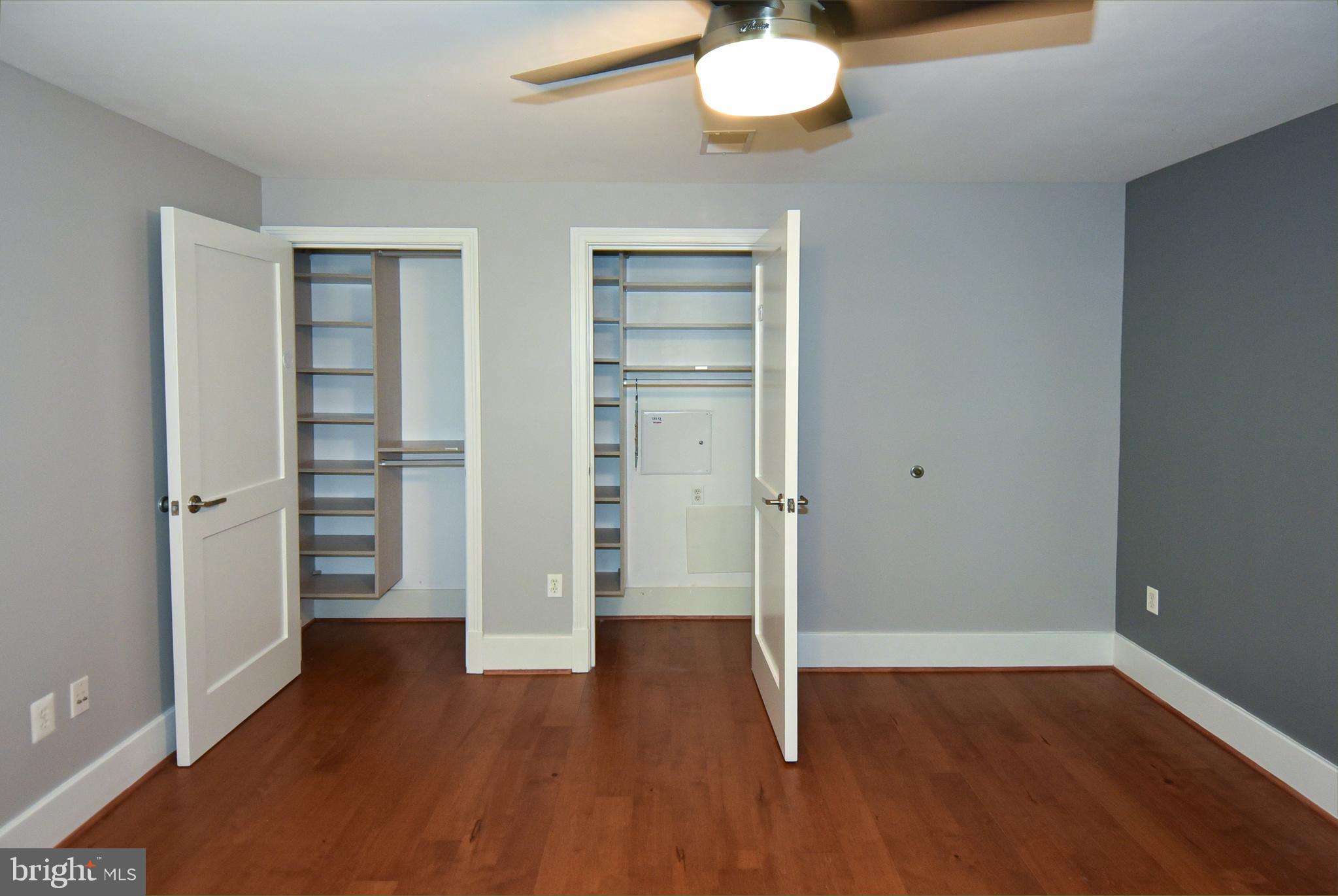2100 11th Street Northwest, Unit G02 Washington, DC 20001 - Photo 29 of 36 an empty room with wooden floor closet and windows