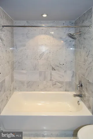 a bathroom with a toilet sink vanity and mirror