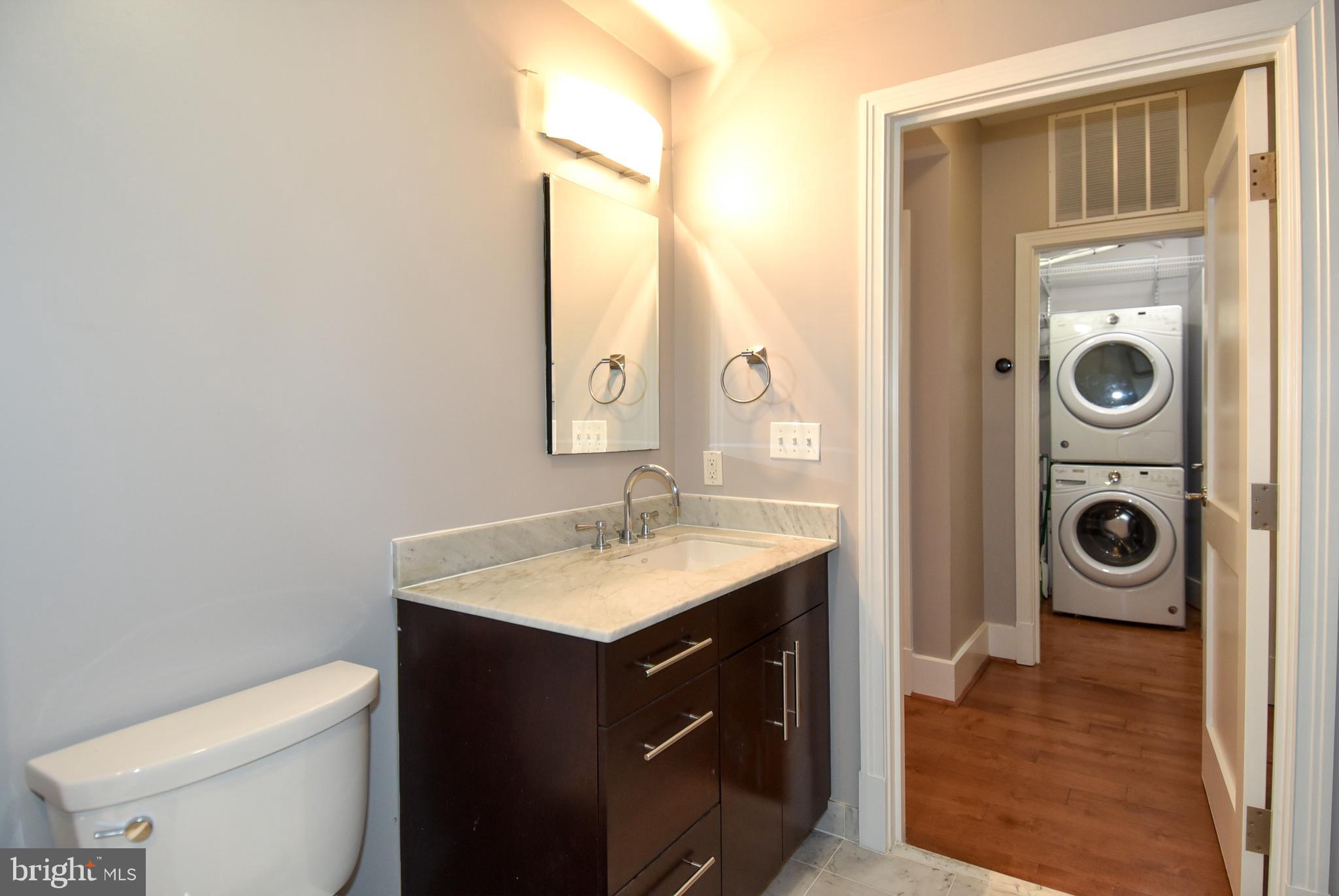 2100 11th Street Northwest, Unit G02 Washington, DC 20001 - Photo 7 of 36 a bathroom with a toilet sink vanity and mirror