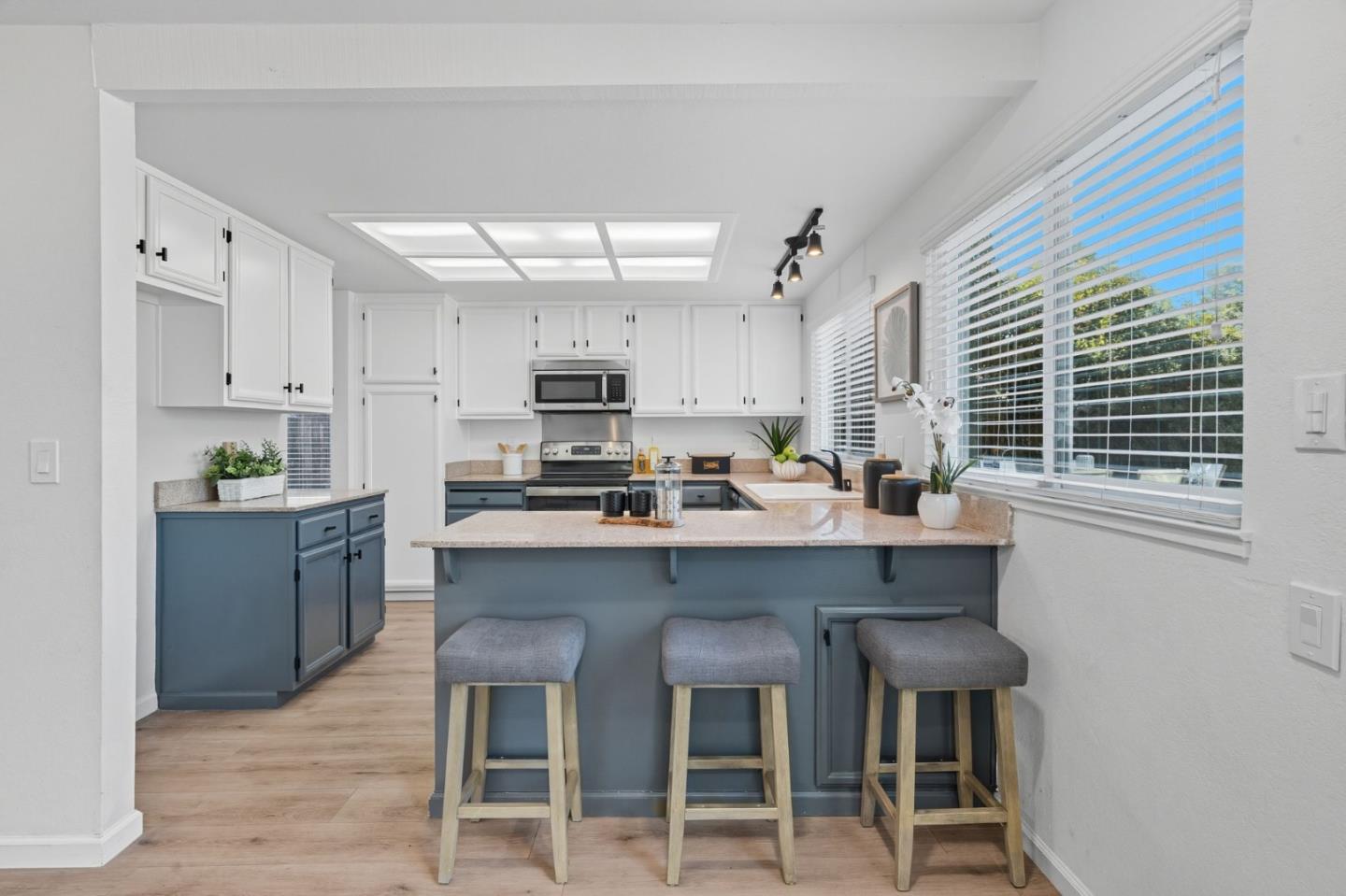 24392 Machado Court Hayward, CA 94541 - Photo 15 of 48 a kitchen with stainless steel appliances a table chairs refrigerator and cabinets