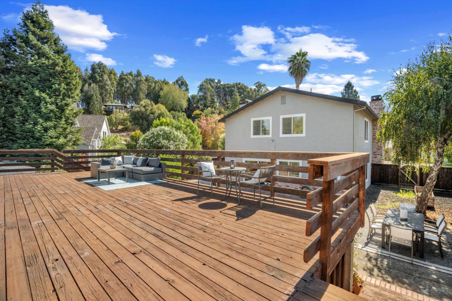24392 Machado Court Hayward, CA 94541 - Photo 38 of 48 a view of a roof deck with table and chairs with wooden floor and fence