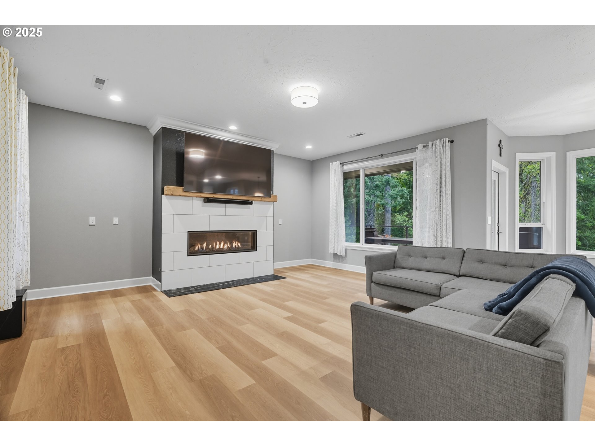 1109 Northwest Frazier Court Portland, OR 97229 - Photo 13 of 44 a living room with furniture and a flat screen tv