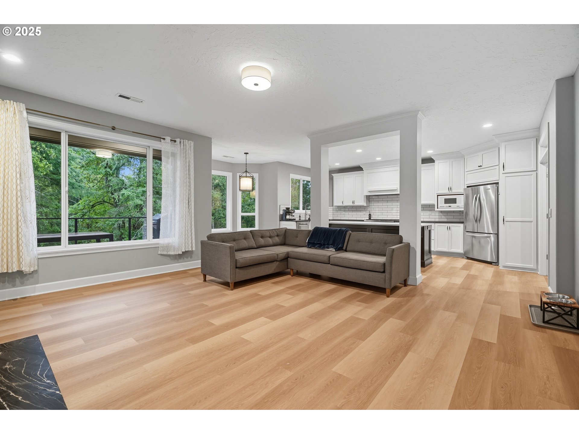 1109 Northwest Frazier Court Portland, OR 97229 - Photo 14 of 44 a living room with furniture and a large window
