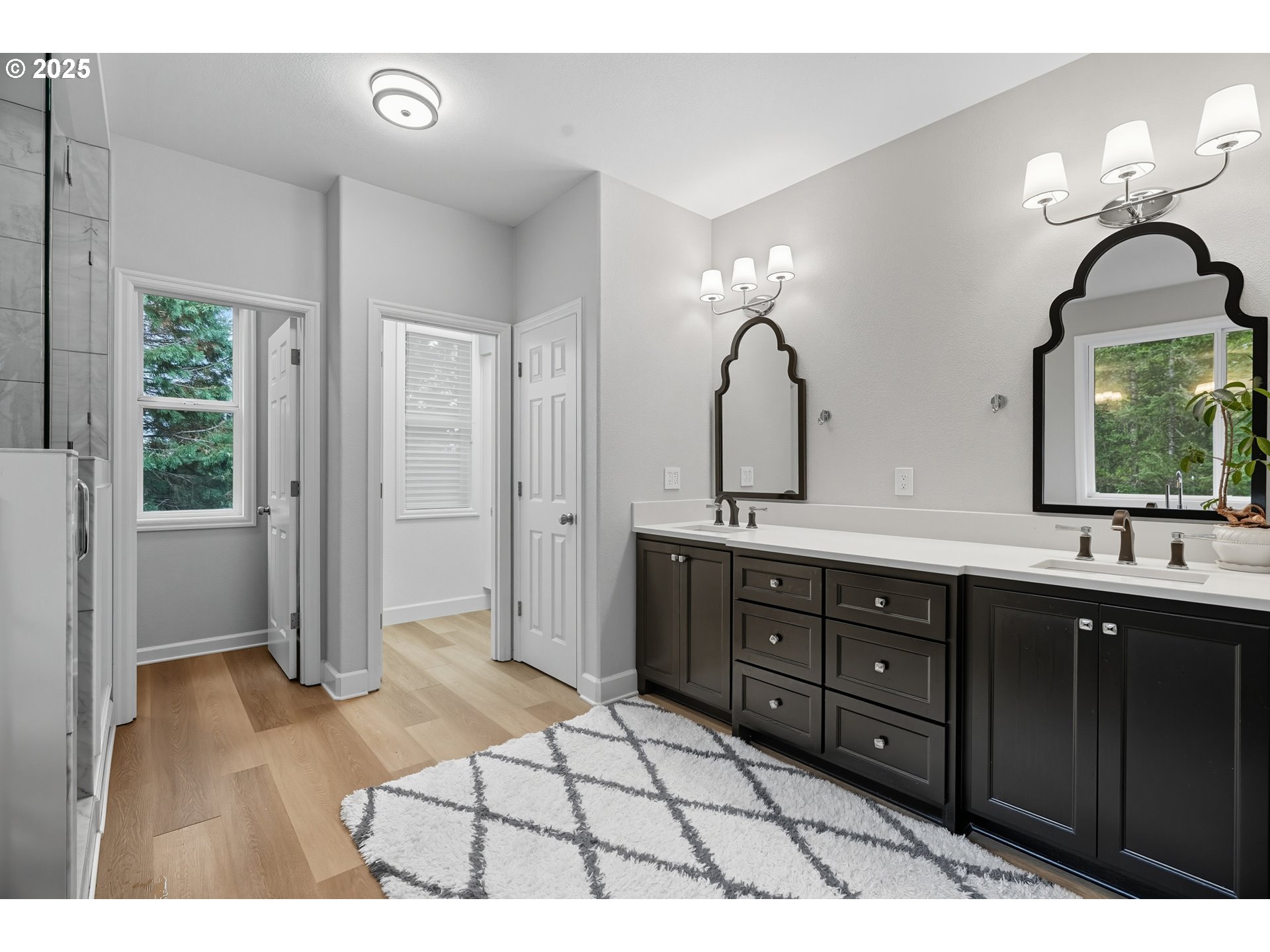 1109 Northwest Frazier Court Portland, OR 97229 - Photo 22 of 44 a spacious bathroom with a granite countertop sink a mirror and a shower