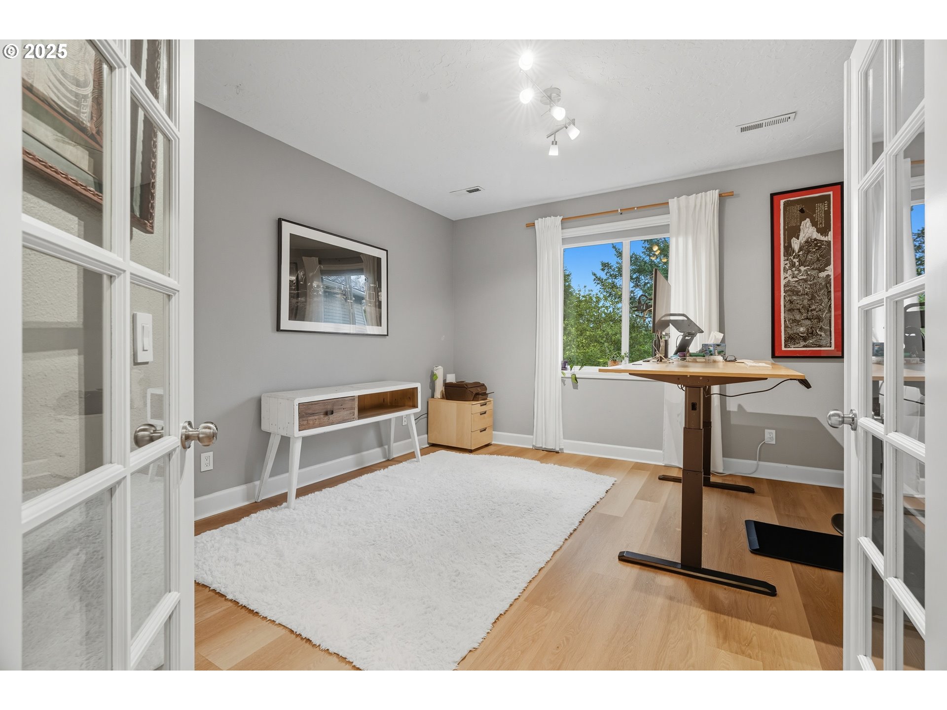 1109 Northwest Frazier Court Portland, OR 97229 - Photo 25 of 44 a living room with furniture a window and a flat screen tv