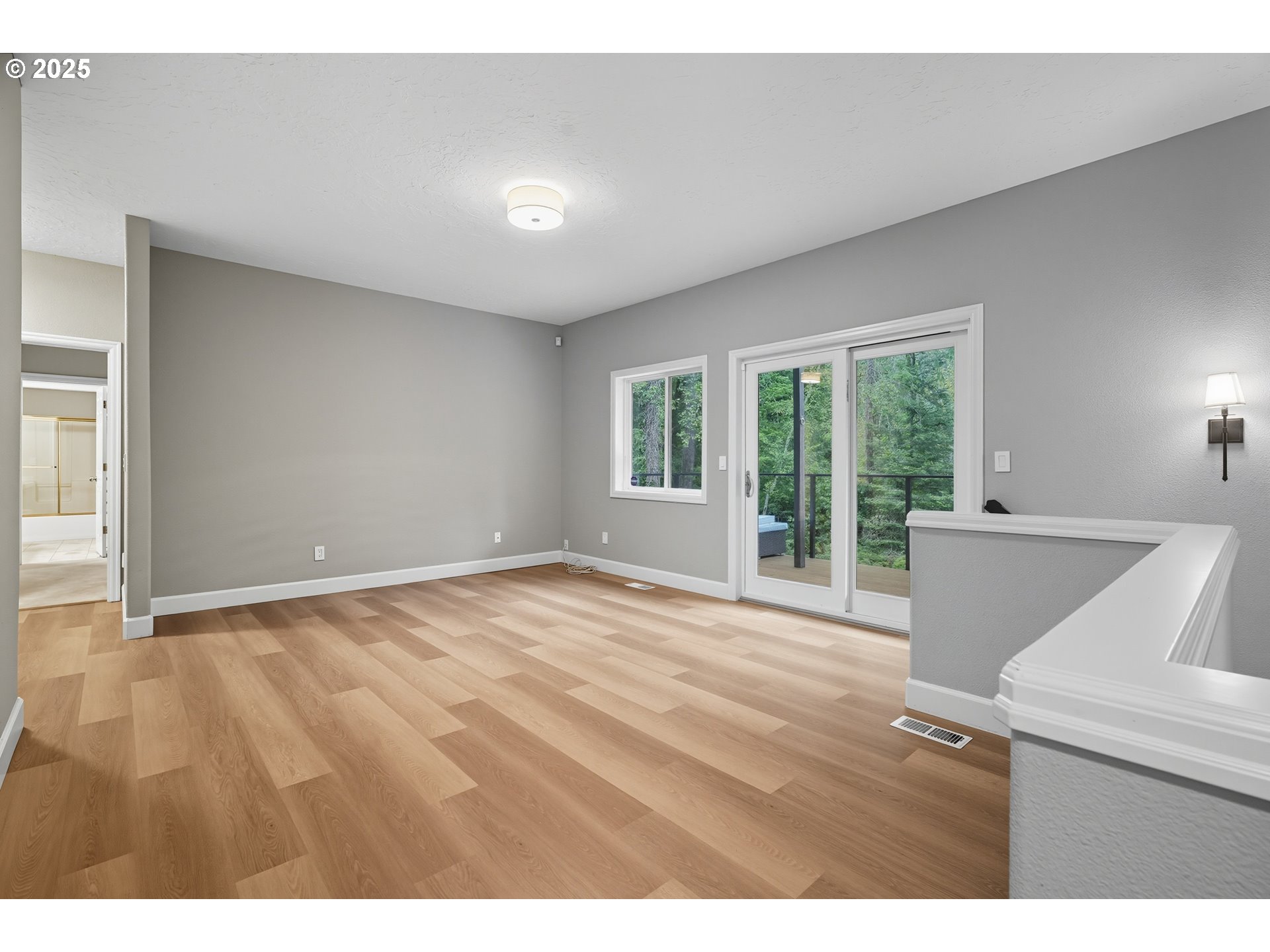 1109 Northwest Frazier Court Portland, OR 97229 - Photo 29 of 44 a view of an empty room with wooden floor and a window
