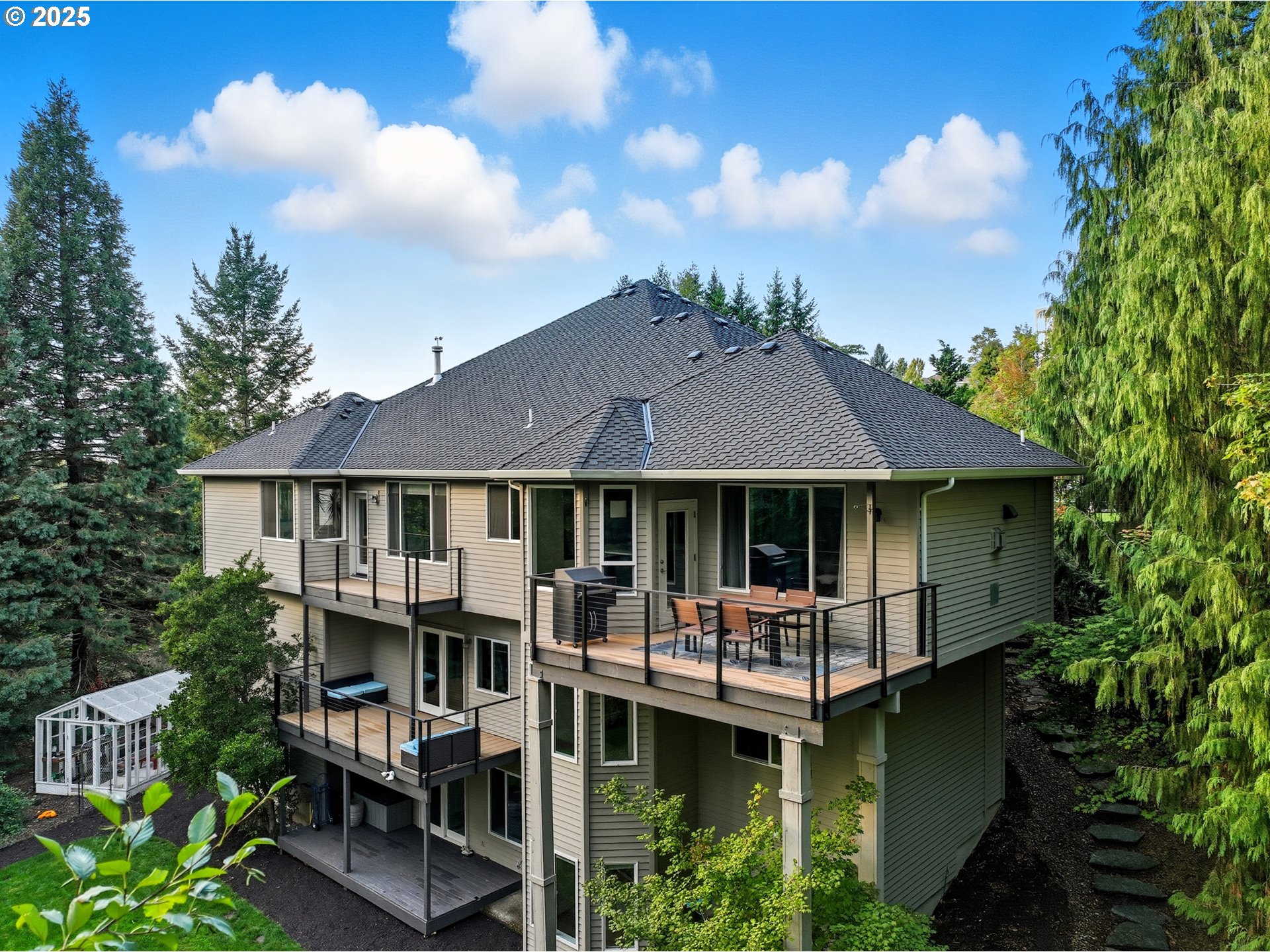 1109 Northwest Frazier Court Portland, OR 97229 - Photo 42 of 44 a front view of a house with a garden and lake view