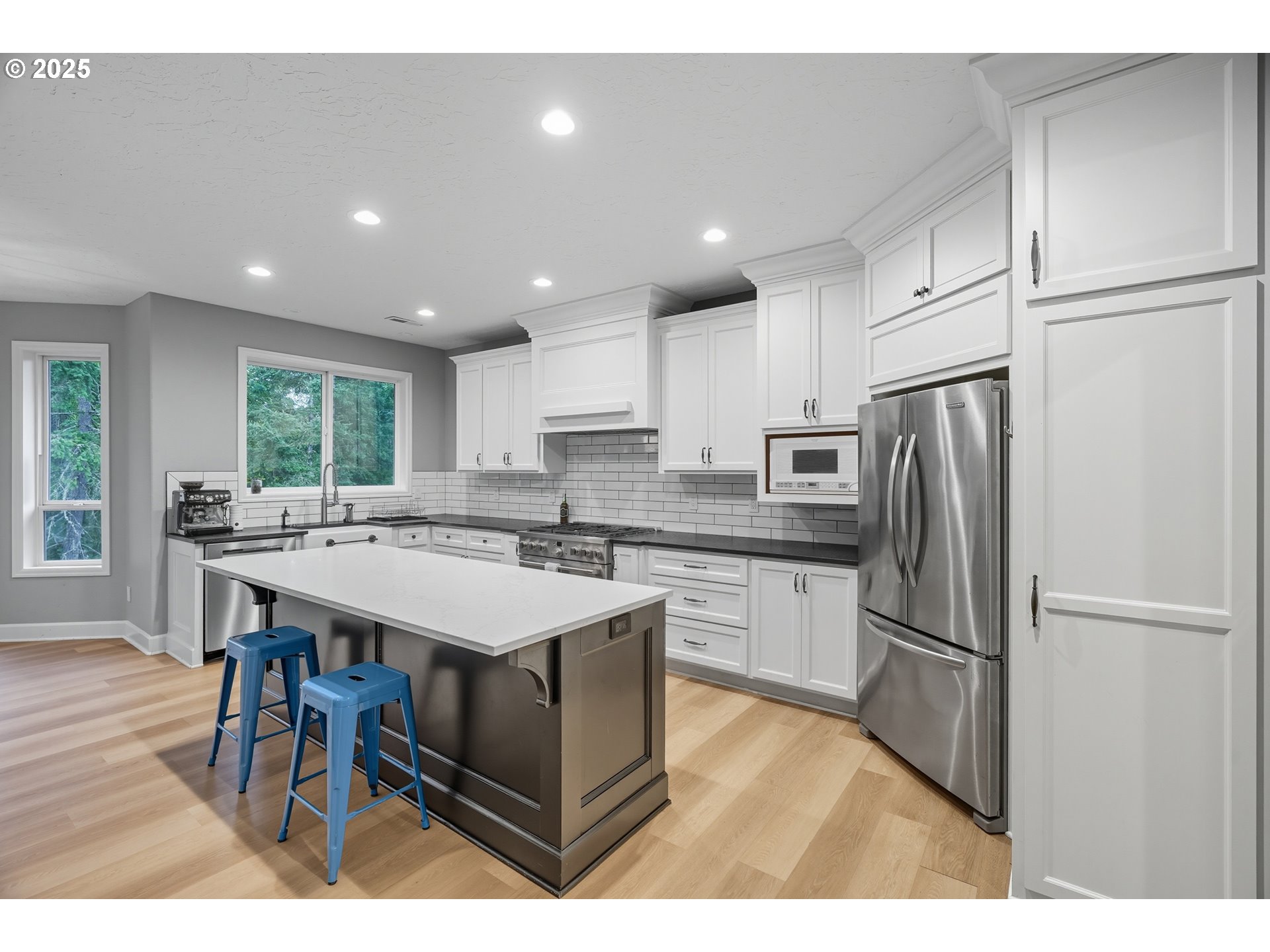 1109 Northwest Frazier Court Portland, OR 97229 - Photo 8 of 44 a kitchen with a refrigerator a sink dishwasher and a refrigerator with wooden floor