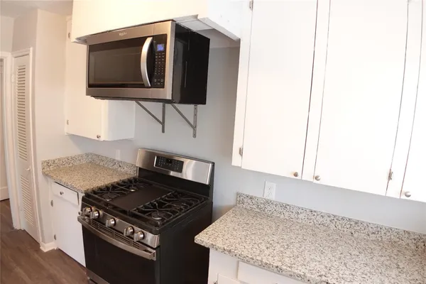 a kitchen with a stove and a microwave