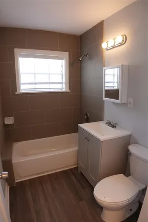 a bathroom with a toilet a sink and bathtub