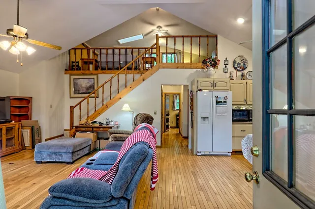 a dining room with furniture a rug and wooden floor