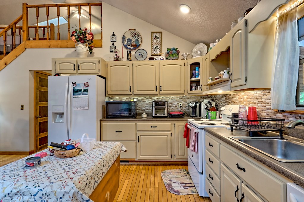 773 Rolling Oaks Road Murphy, NC 28906 - Photo 18 of 72 a kitchen with stainless steel appliances granite countertop a sink stove and cabinets