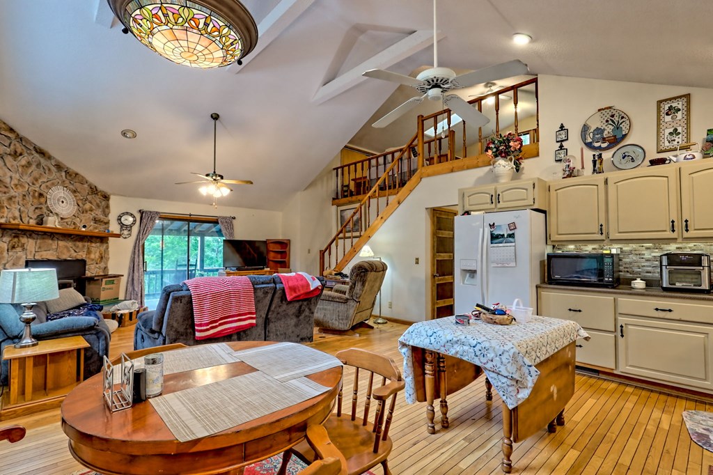 773 Rolling Oaks Road Murphy, NC 28906 - Photo 19 of 72 a dining room with furniture a rug and wooden floor