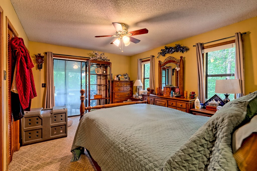 773 Rolling Oaks Road Murphy, NC 28906 - Photo 23 of 72 a bed room with a bed and a flat tv screen