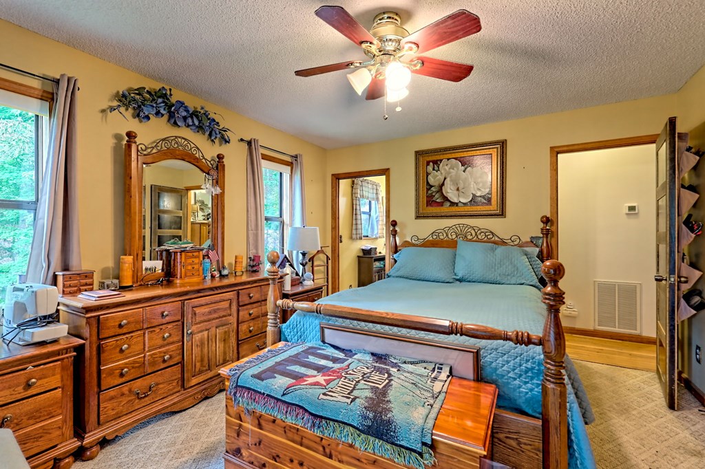 773 Rolling Oaks Road Murphy, NC 28906 - Photo 24 of 72 a bed room with a bed and a chandelier