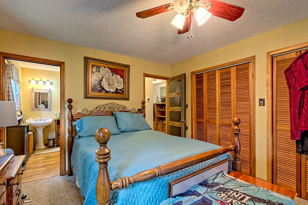 773 Rolling Oaks Road Murphy, NC 28906 - Photo 25 of 72 a bed room with a bed and a chandelier
