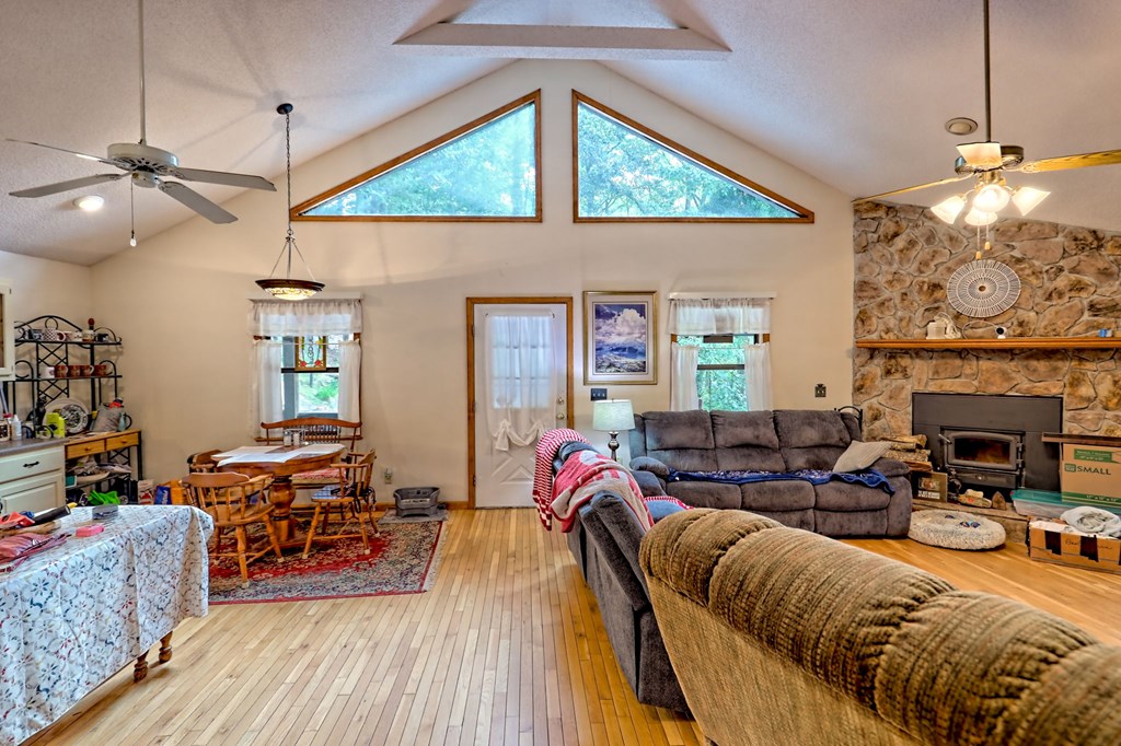 773 Rolling Oaks Road Murphy, NC 28906 - Photo 30 of 72 a living room with furniture a fireplace and wooden floor