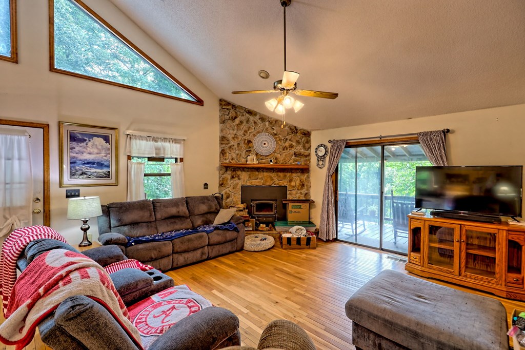 773 Rolling Oaks Road Murphy, NC 28906 - Photo 31 of 72 a living room with furniture a fireplace and a flat screen tv