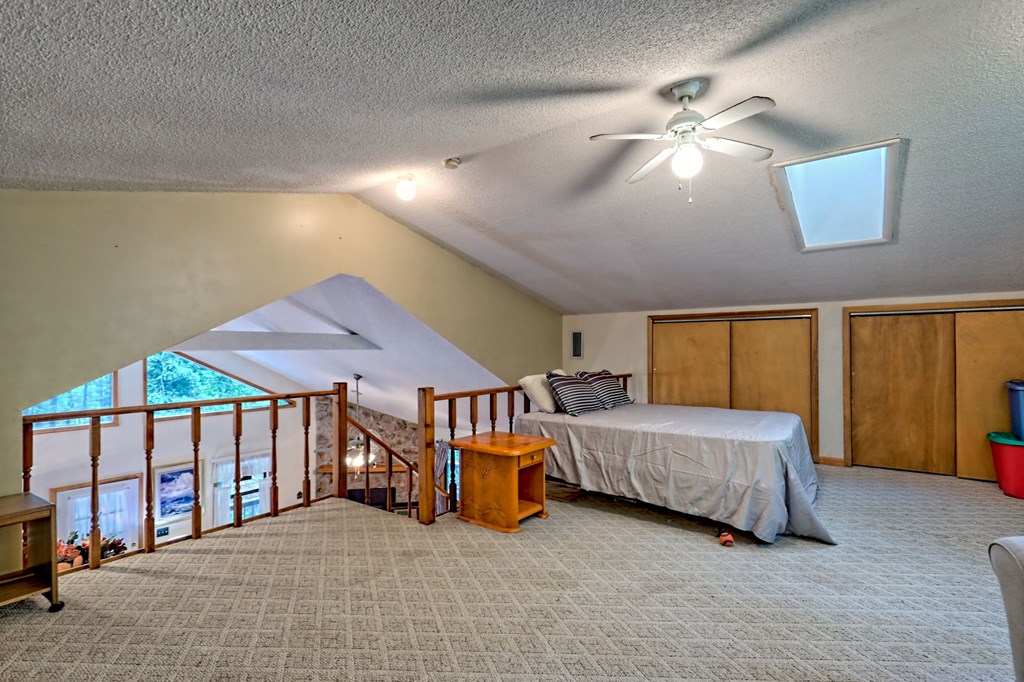 773 Rolling Oaks Road Murphy, NC 28906 - Photo 33 of 72 a bedroom with a bed and a chandelier
