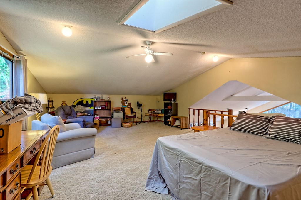 773 Rolling Oaks Road Murphy, NC 28906 - Photo 34 of 72 a bedroom with furniture and a chandelier