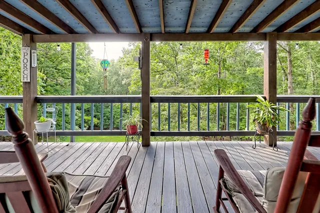 a view of porch with a table and chairs