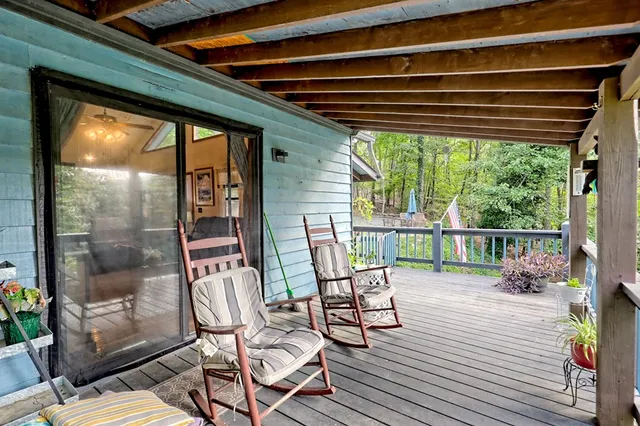 a view of backyard with swimming pool and green space