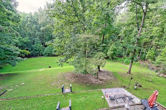 a view of a swimming pool with a yard in front of it