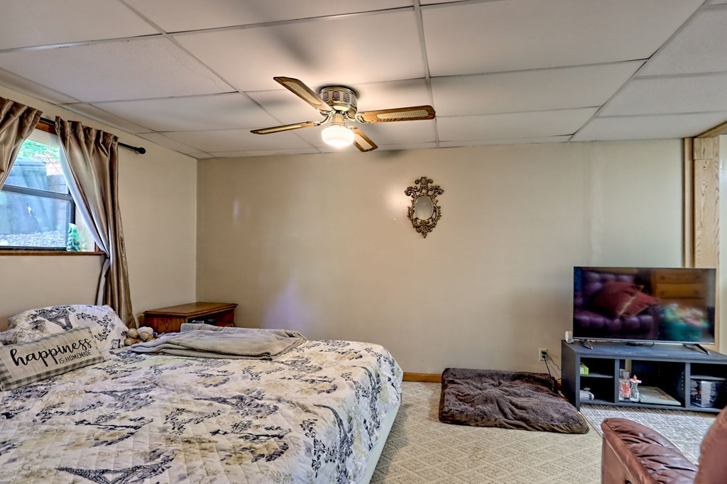 773 Rolling Oaks Road Murphy, NC 28906 - Photo 46 of 72 a bedroom with a bed and a chandelier