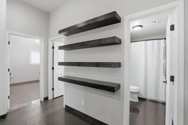 a kitchen with kitchen island white cabinets and refrigerator