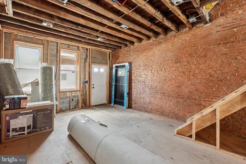 a spacious bedroom with a bed and a chandelier