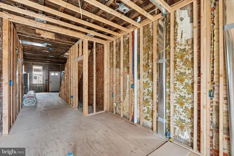 a view of a hallway with wooden floor and entryway