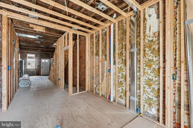 a view of a hallway with wooden floor and entryway