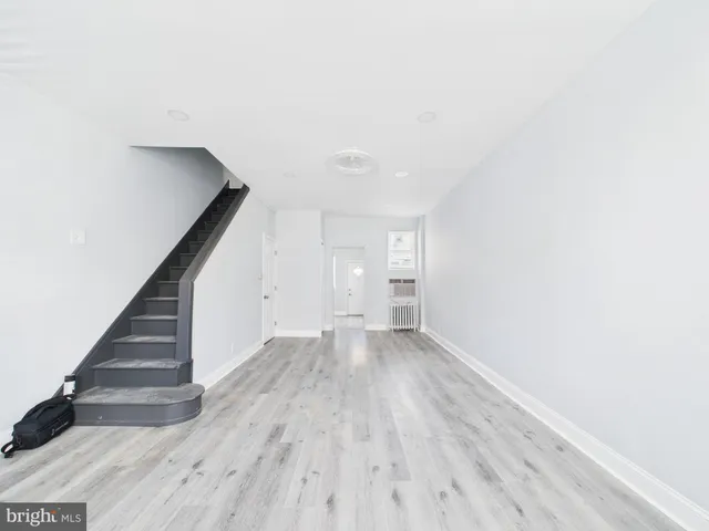 a view of an empty room with stairs and ventilation