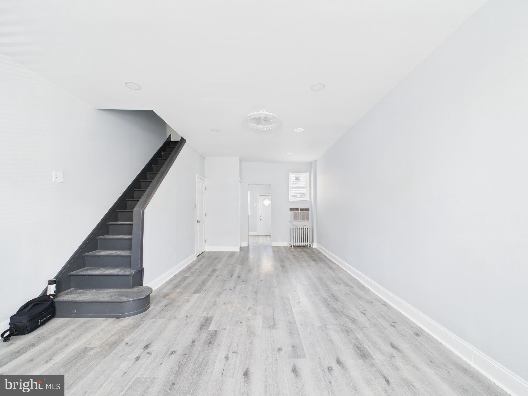 a view of an empty room with stairs and ventilation
