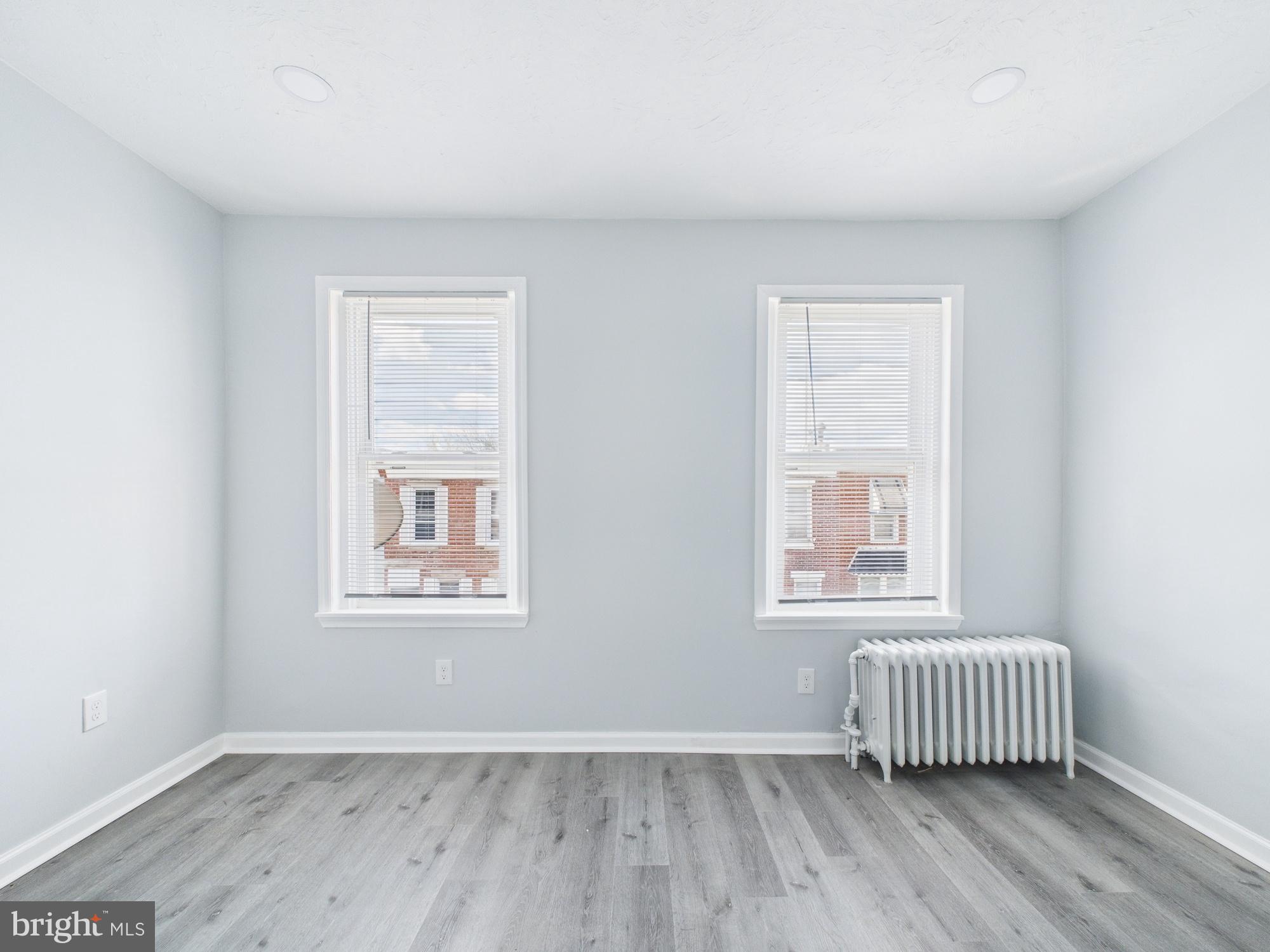 2021 Granite Street Philadelphia, PA 19124 - Photo 7 of 9 an empty room with a window and wooden floor