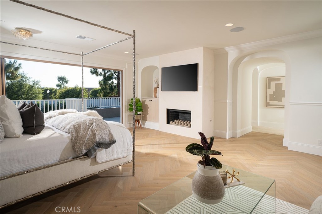 17 Boardwalk Newport Beach, CA 92660 - Photo 19 of 58 a living room with couch a fireplace and a floor to ceiling window