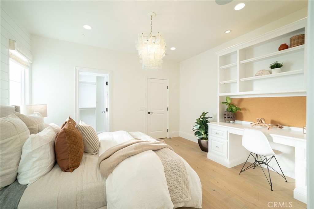 17 Boardwalk Newport Beach, CA 92660 - Photo 26 of 58 a large bedroom with a bed and a chandelier