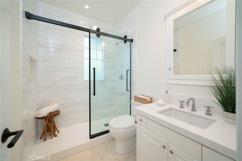 17 Boardwalk Newport Beach, CA 92660 - Photo 29 of 58 a bathroom with a shower sink vanity mirror and toilet