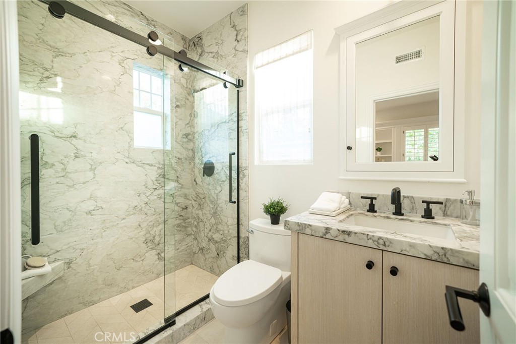 17 Boardwalk Newport Beach, CA 92660 - Photo 33 of 58 a bathroom with a granite countertop sink toilet and shower