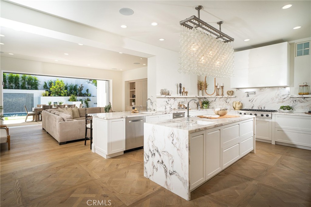 17 Boardwalk Newport Beach, CA 92660 - Photo 4 of 58 a kitchen with white cabinets and white appliances