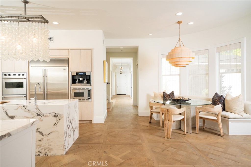 17 Boardwalk Newport Beach, CA 92660 - Photo 10 of 58 a living room with furniture a chandelier and a dining table with a kitchen view