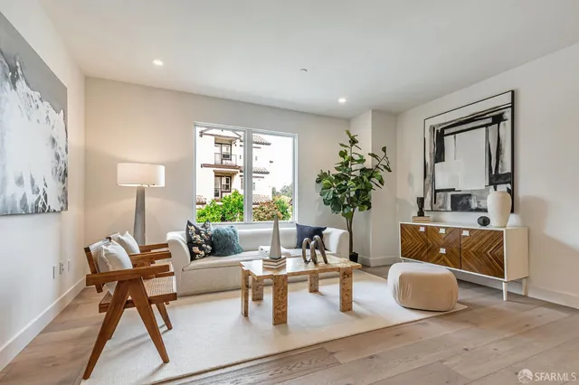 a living room with furniture and a potted plant