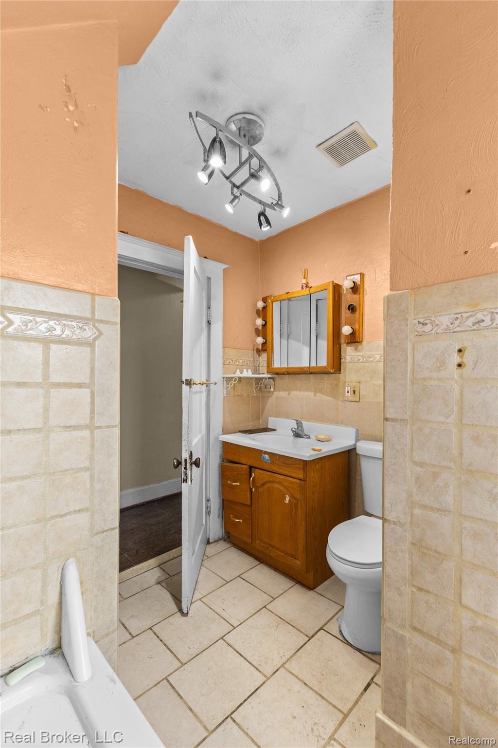 352 Perry Street Pontiac, MI 48342 - Photo 22 of 30 Bathroom featuring vanity, tile walls, and a tub