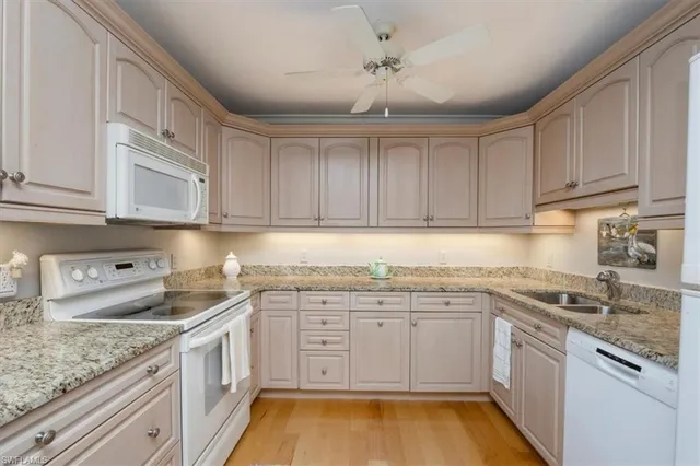 a kitchen with stainless steel appliances granite countertop a sink and cabinets