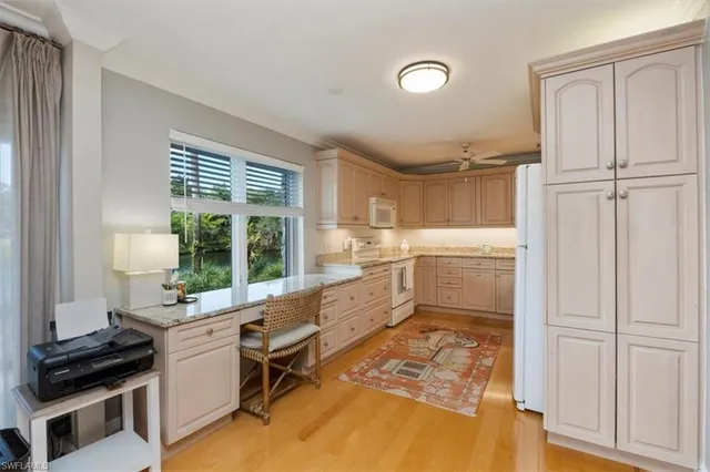 a kitchen with a refrigerator and a stove